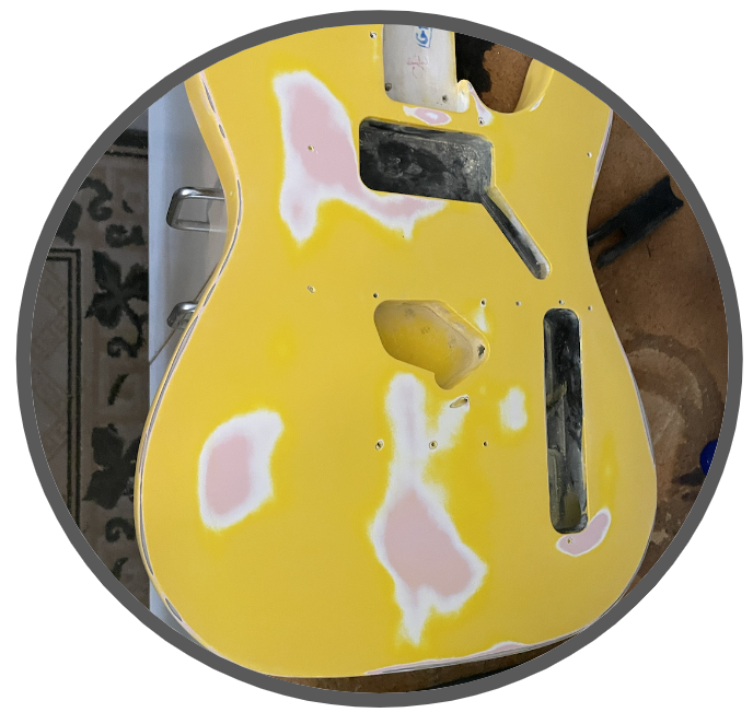 This is the sanding down of that guitar, getting it ready for painting. It is work I did in my father's garage shop, so it looks a little like a home project.